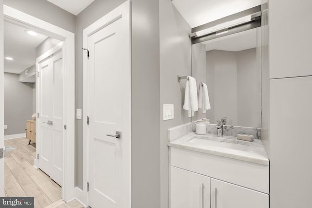 bathroom featuring hardwood / wood-style flooring and vanity