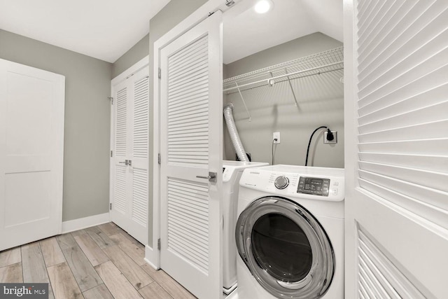 laundry room featuring washer / dryer and light hardwood / wood-style floors