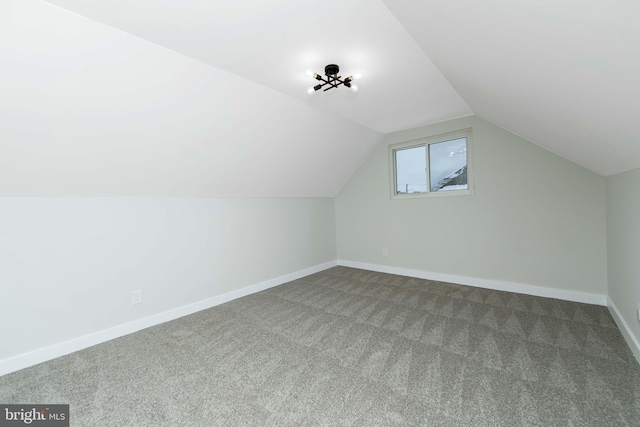 additional living space with lofted ceiling and carpet floors