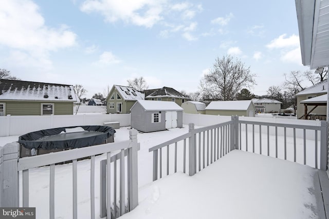 snow covered deck with a storage unit