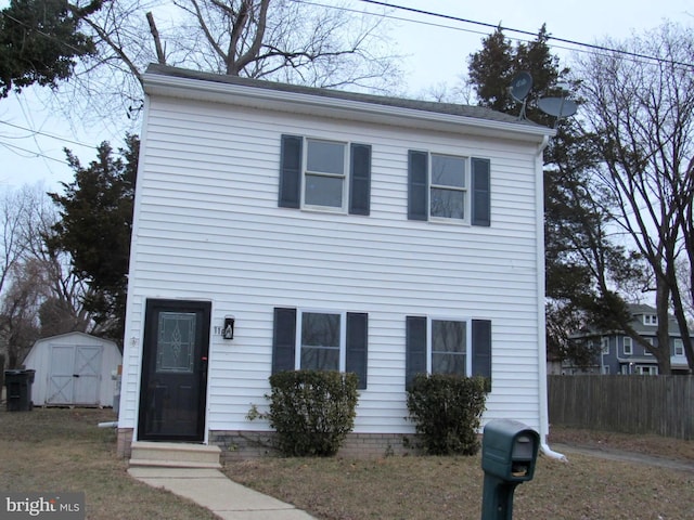 view of front facade featuring a storage shed, an outdoor structure, fence, and entry steps