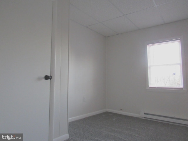 unfurnished room featuring a paneled ceiling, a baseboard radiator, dark carpet, and baseboards