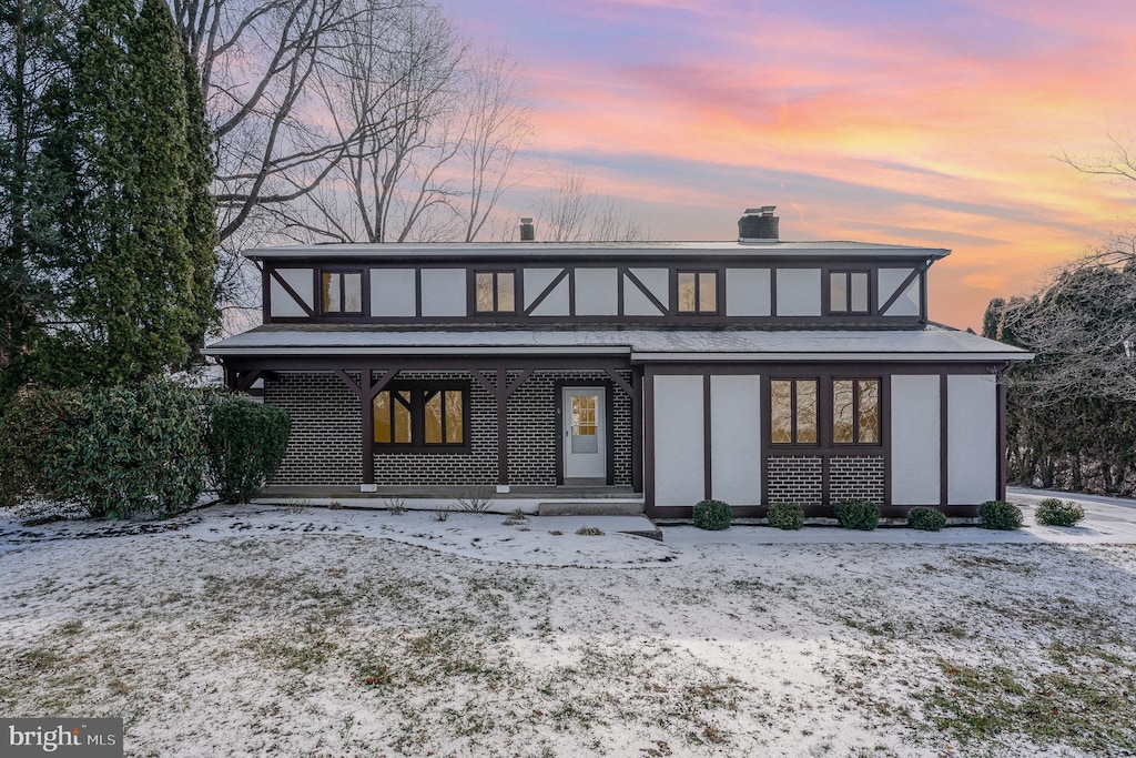 view of snow covered rear of property