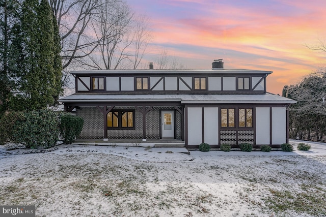 view of snow covered rear of property