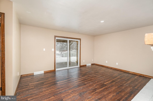 spare room with dark hardwood / wood-style floors