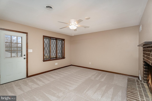 interior space featuring ceiling fan and a brick fireplace