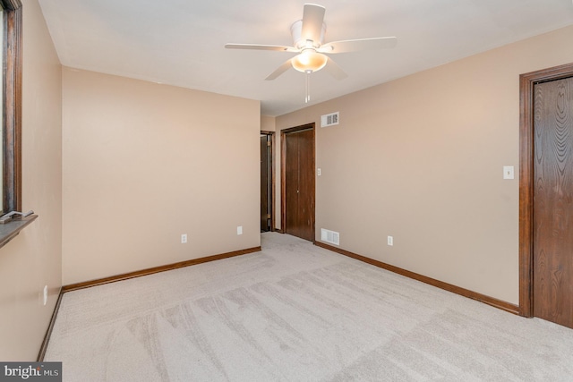 unfurnished room featuring ceiling fan and light carpet