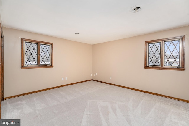 empty room featuring light colored carpet