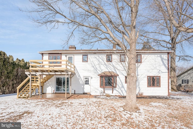 snow covered property with a deck