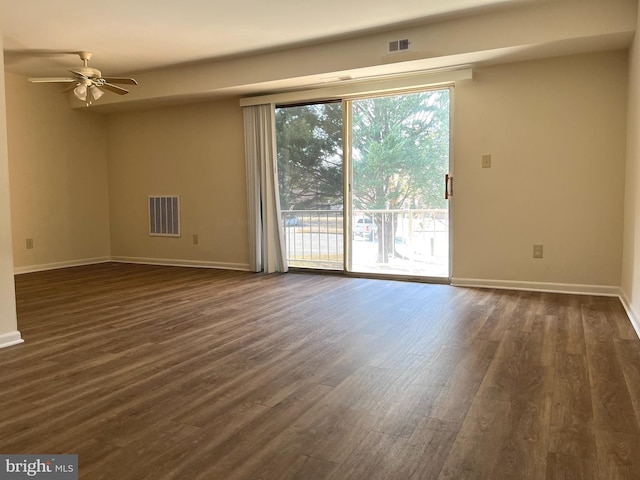 empty room featuring ceiling fan and dark wood-type flooring