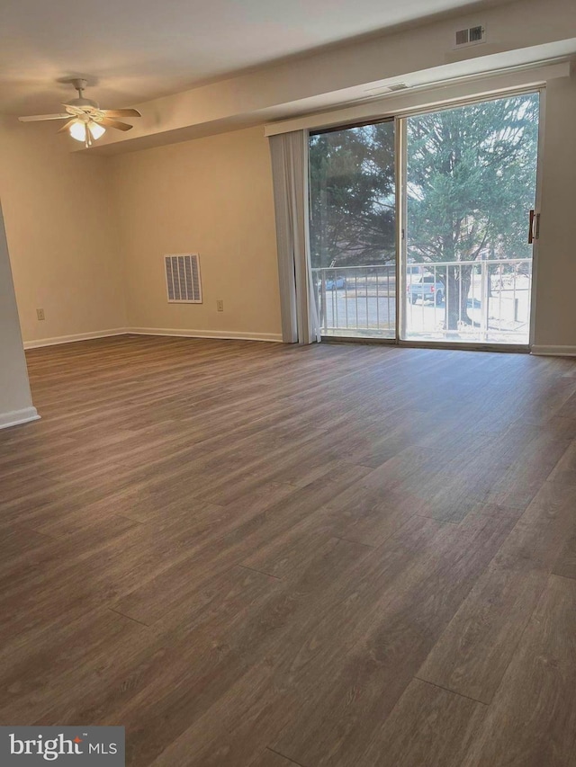 spare room with ceiling fan and dark hardwood / wood-style flooring