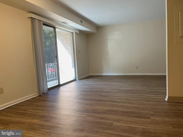 empty room with dark hardwood / wood-style flooring