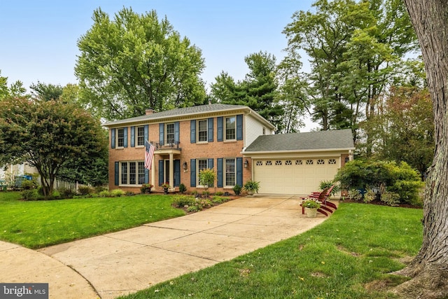 colonial inspired home featuring a garage and a front yard