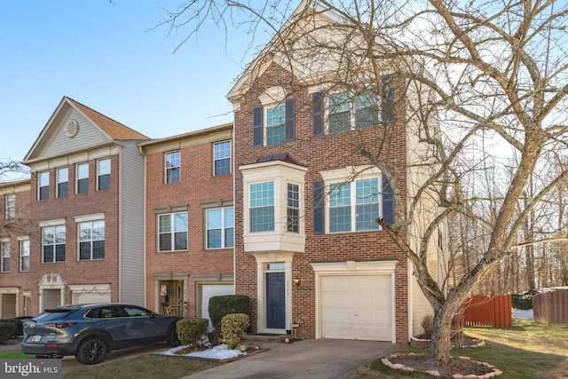 multi unit property featuring a garage, aphalt driveway, and brick siding