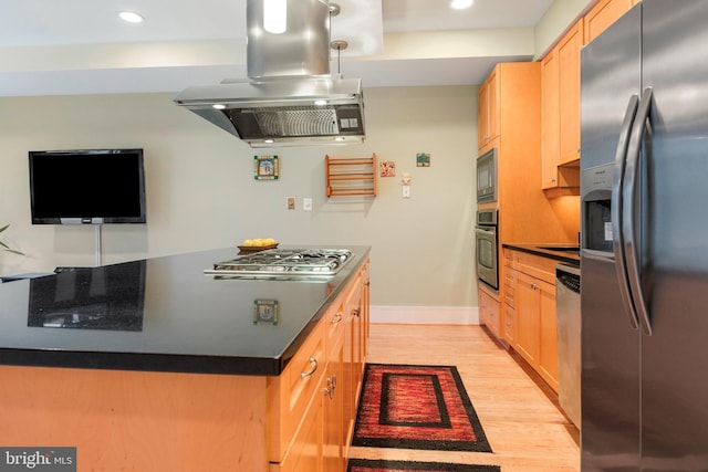 kitchen featuring light brown cabinetry, light wood-type flooring, island exhaust hood, and appliances with stainless steel finishes