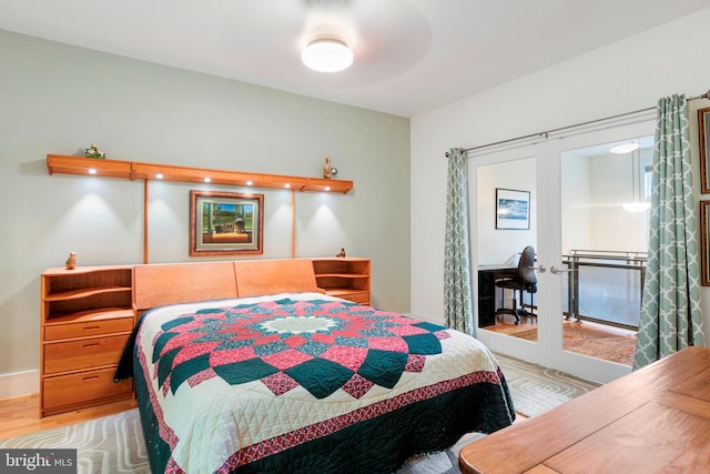 bedroom with french doors and light hardwood / wood-style flooring