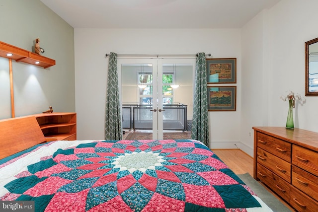 bedroom with french doors and light wood-type flooring