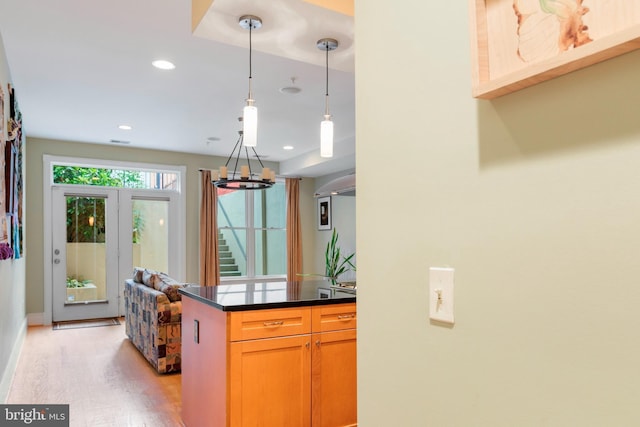 kitchen featuring decorative light fixtures and light hardwood / wood-style flooring