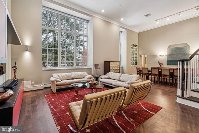 living room with visible vents, stairs, hardwood / wood-style floors, rail lighting, and crown molding