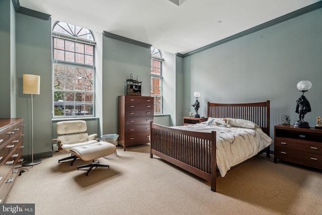 bedroom with carpet floors and crown molding