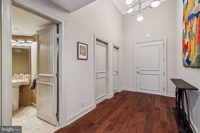 hallway with baseboards and wood finished floors