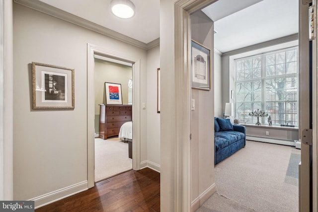 hallway featuring a healthy amount of sunlight, a baseboard radiator, and crown molding