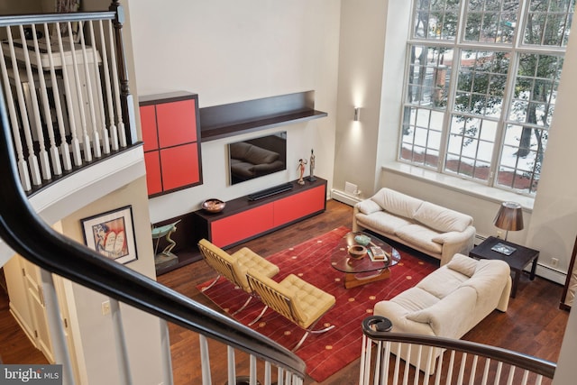 living area featuring baseboards and wood finished floors