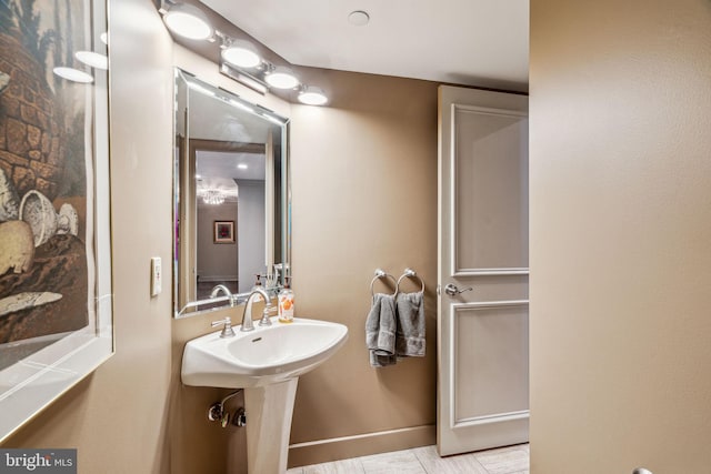 bathroom with baseboards and a sink