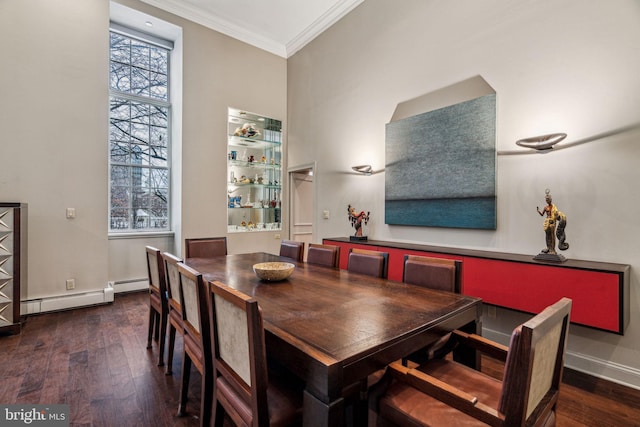 dining room featuring ornamental molding, a baseboard radiator, baseboards, and wood finished floors