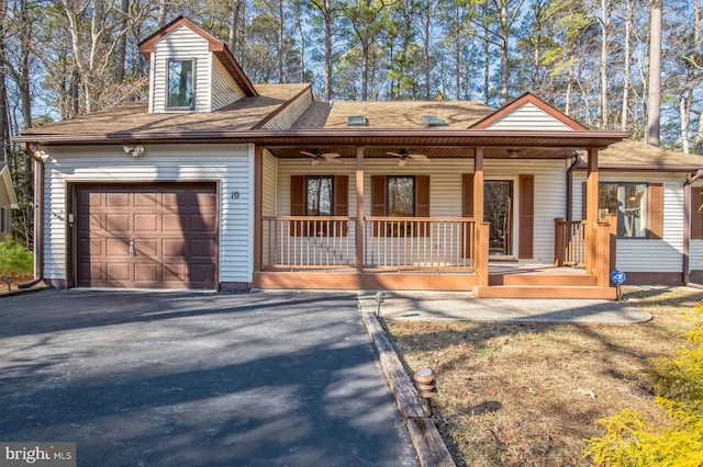 view of front of house featuring a garage, a porch, a ceiling fan, and aphalt driveway