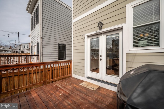 deck featuring french doors and a grill