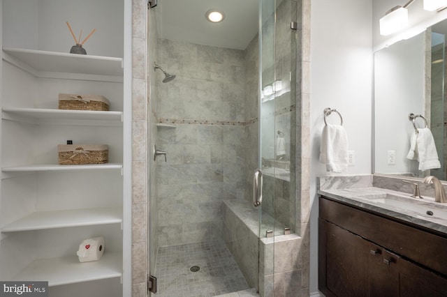 bathroom featuring vanity and an enclosed shower