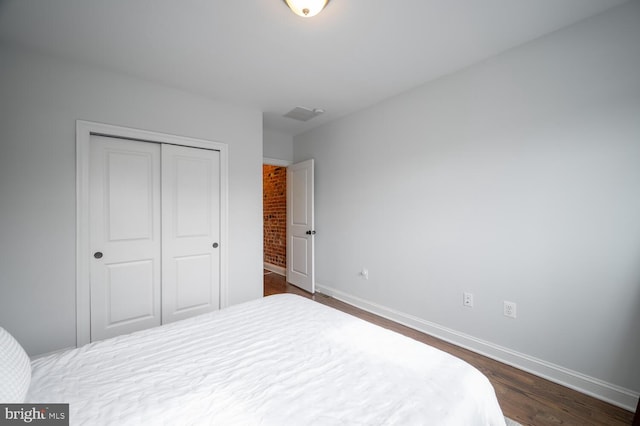 bedroom featuring dark hardwood / wood-style flooring and a closet