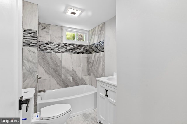 full bathroom featuring vanity, tiled shower / bath, and toilet