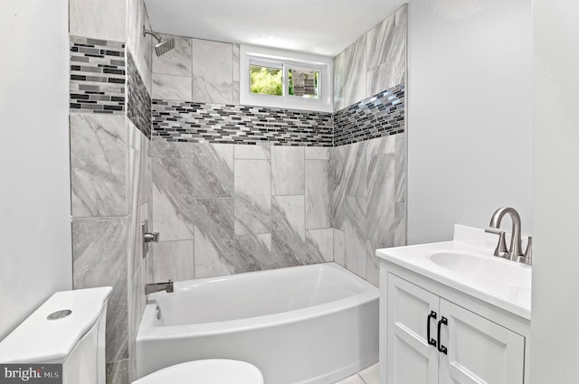 full bathroom with tiled shower / bath combo, vanity, and toilet