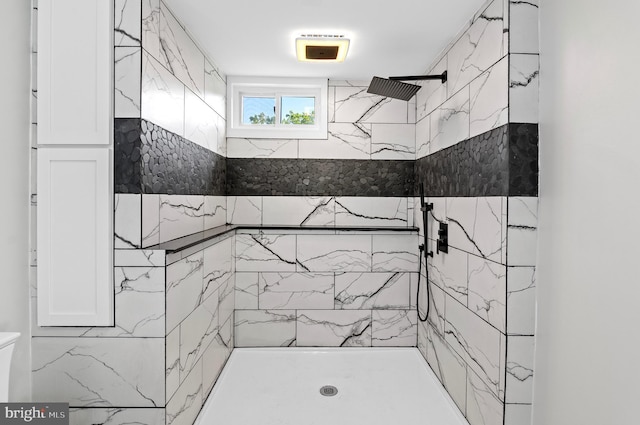 bathroom with tiled shower