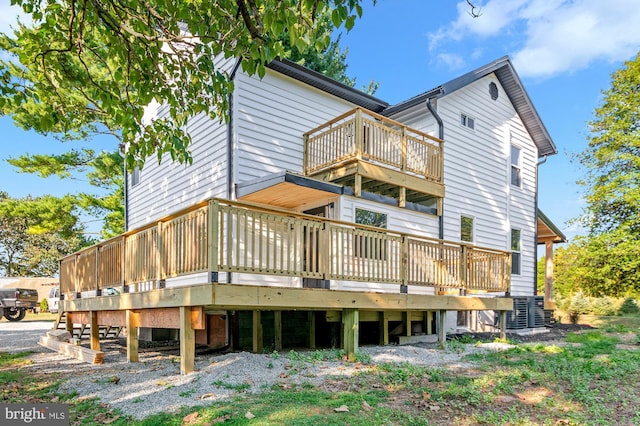 rear view of property with a wooden deck