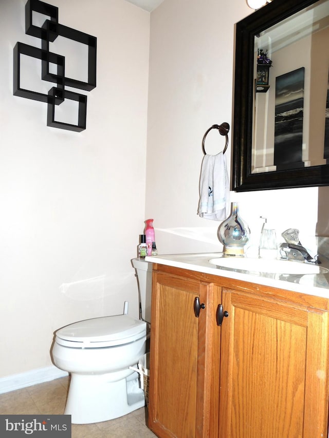 bathroom with vanity, toilet, and tile patterned flooring