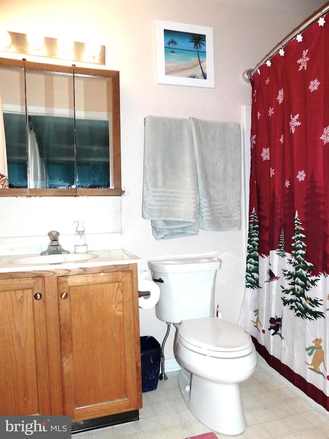 bathroom with vanity, toilet, and walk in shower