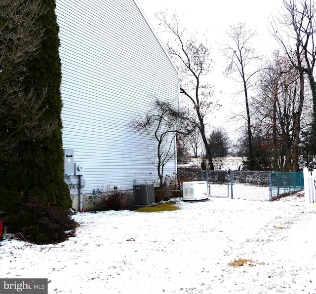 yard covered in snow with central AC unit