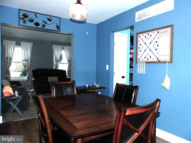 dining space featuring plenty of natural light and hardwood / wood-style floors