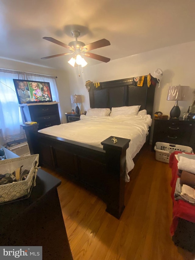 bedroom with hardwood / wood-style flooring and ceiling fan