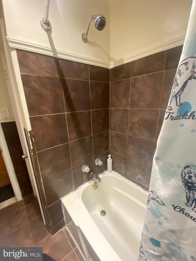 bathroom featuring tile patterned floors and shower / bath combo with shower curtain