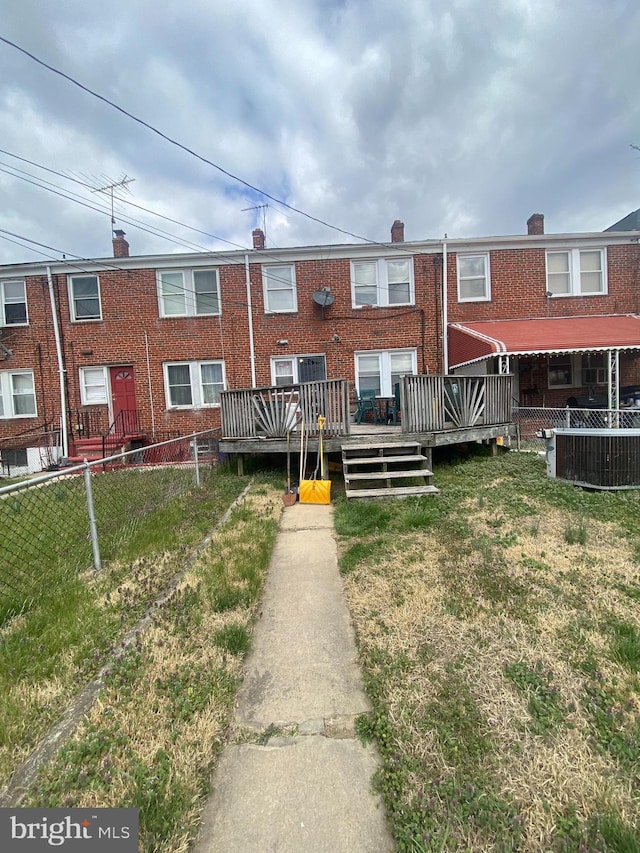 multi unit property featuring a wooden deck, a front yard, and central AC unit