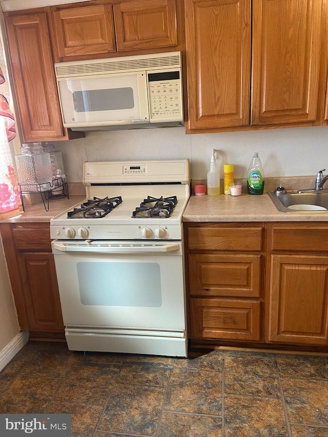 kitchen with sink and white appliances