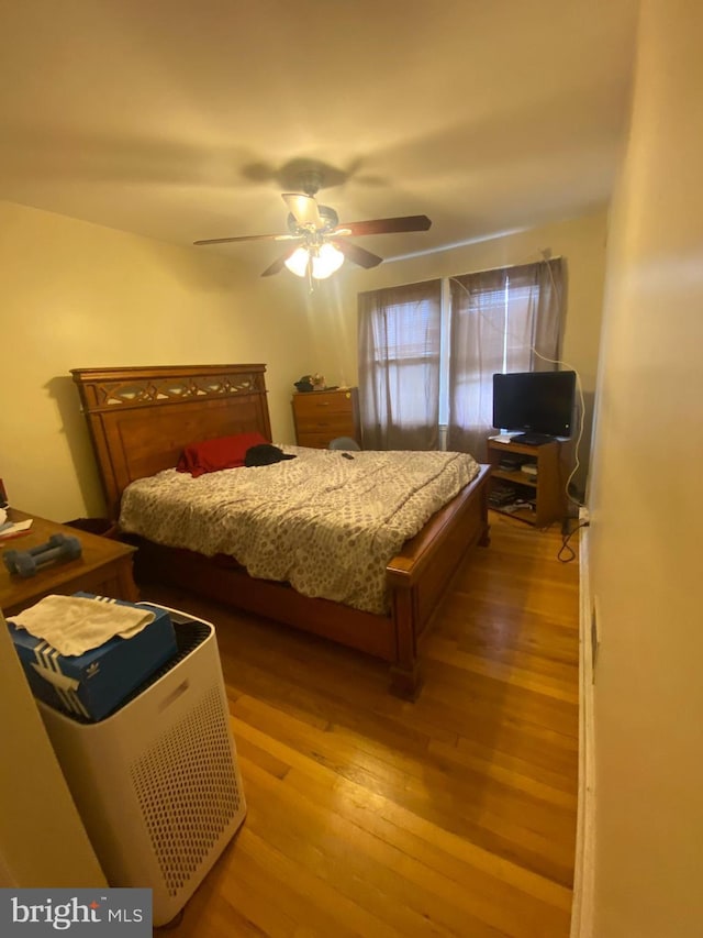 bedroom with ceiling fan and light hardwood / wood-style floors