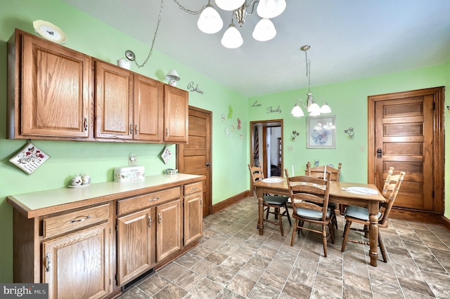 kitchen with hanging light fixtures and an inviting chandelier