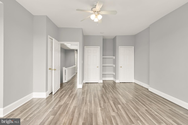 unfurnished bedroom with light wood-style floors, baseboards, and a ceiling fan