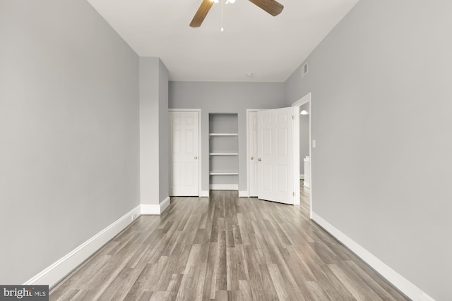 unfurnished bedroom featuring visible vents, ceiling fan, light wood-style flooring, and baseboards