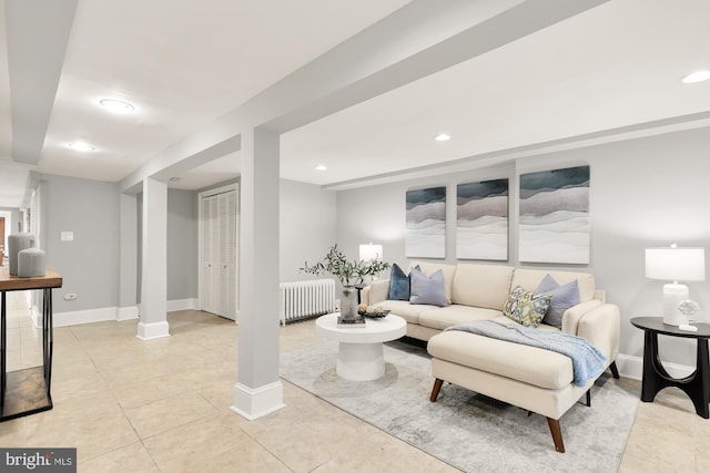 living area featuring recessed lighting, baseboards, radiator heating unit, and light tile patterned floors